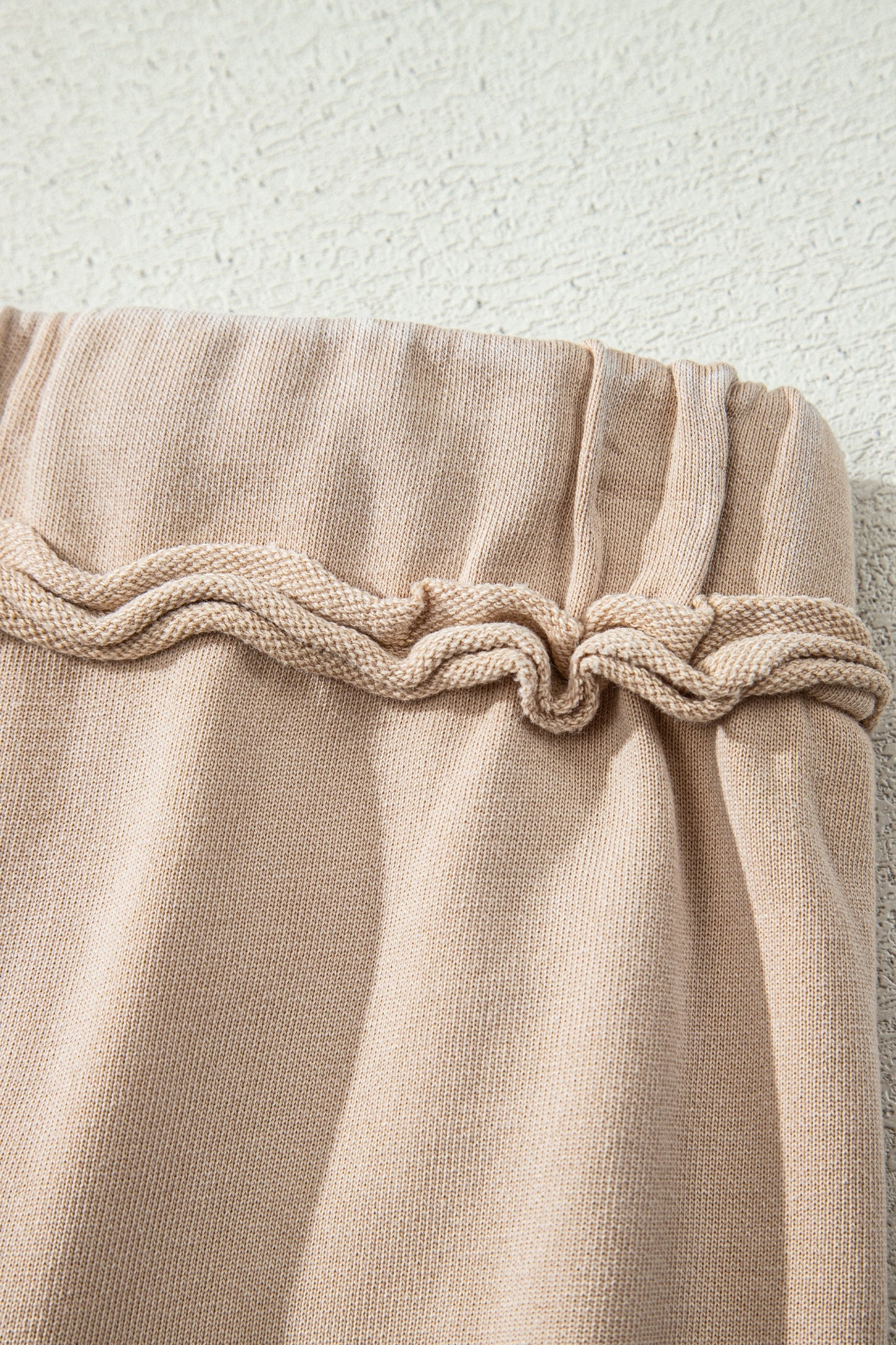 Sand washed cotton wide leg pants with drawstring waist, oversized patch pockets, and relaxed fit.