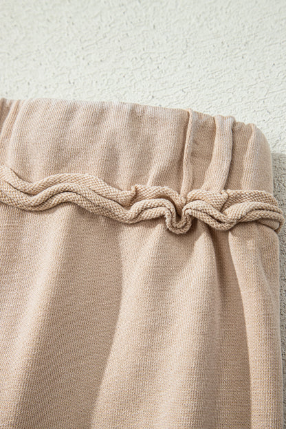 Sand washed cotton wide leg pants with drawstring waist, oversized patch pockets, and relaxed fit.
