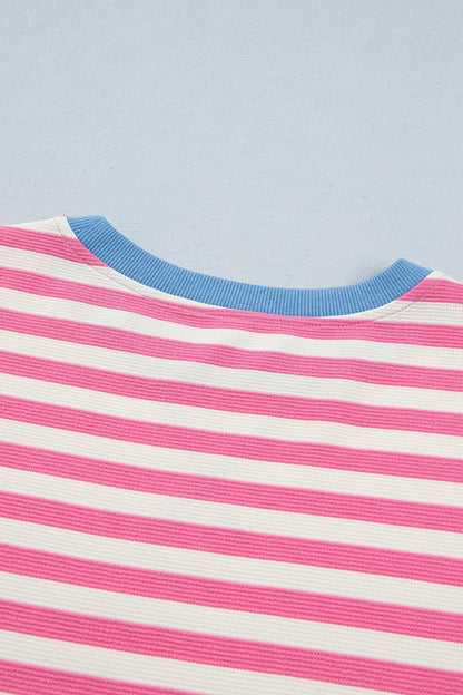 Pink and white textured striped knit short sleeve top with blue contrast ribbed neckline and sleeve cuffs, relaxed fit, and crew neckline.