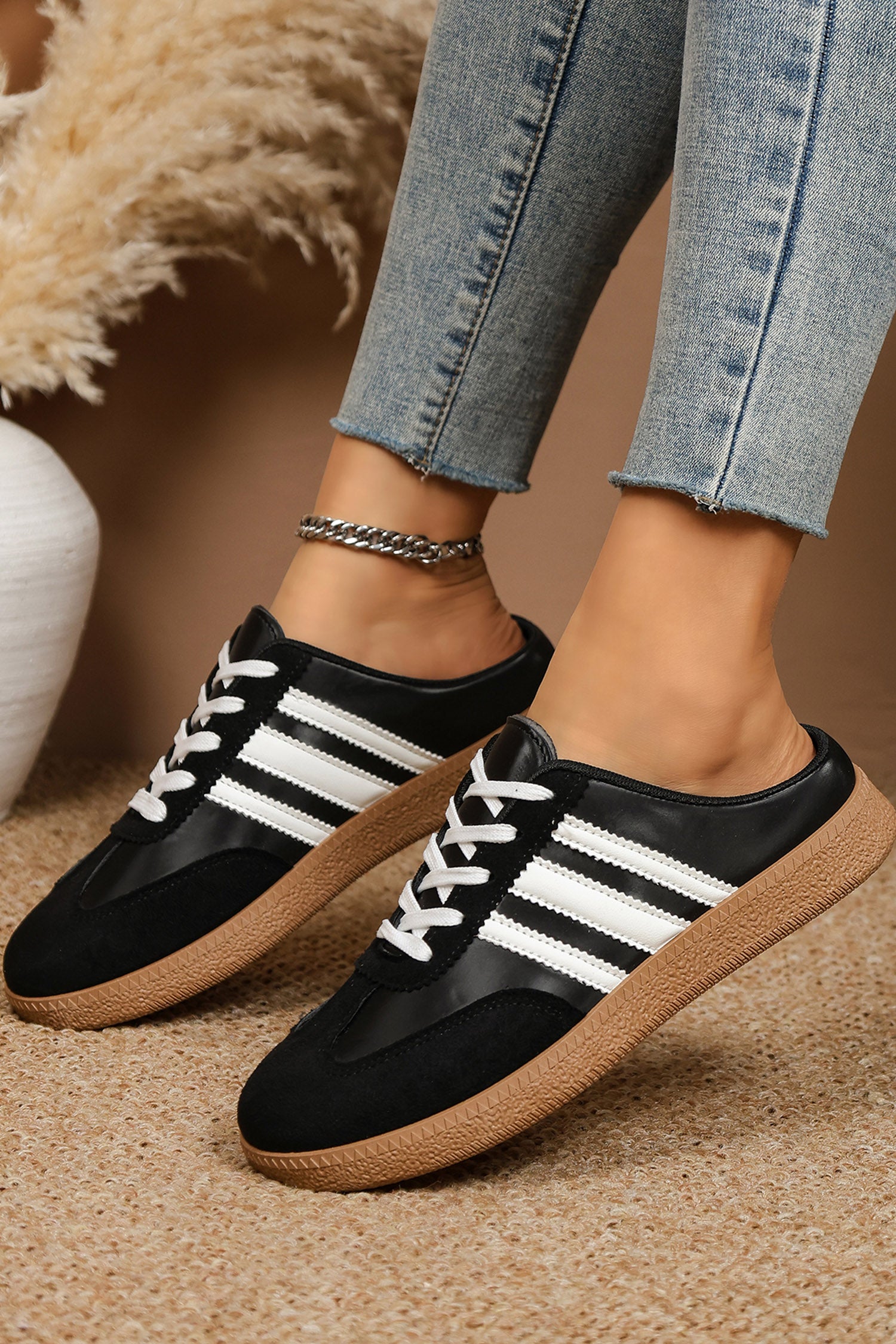 Women's Midnight Noir retro lace-up casual sneakers featuring a black faux leather upper, suede-look overlays, white side stripes, white laces, and a gum rubber sole.