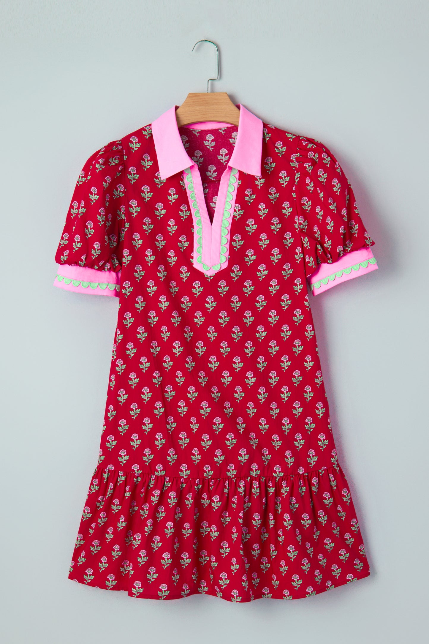 Red floral mini dress with pink collared neckline, mint scalloped trim, short puff sleeves, and a ruffled drop-waist hem