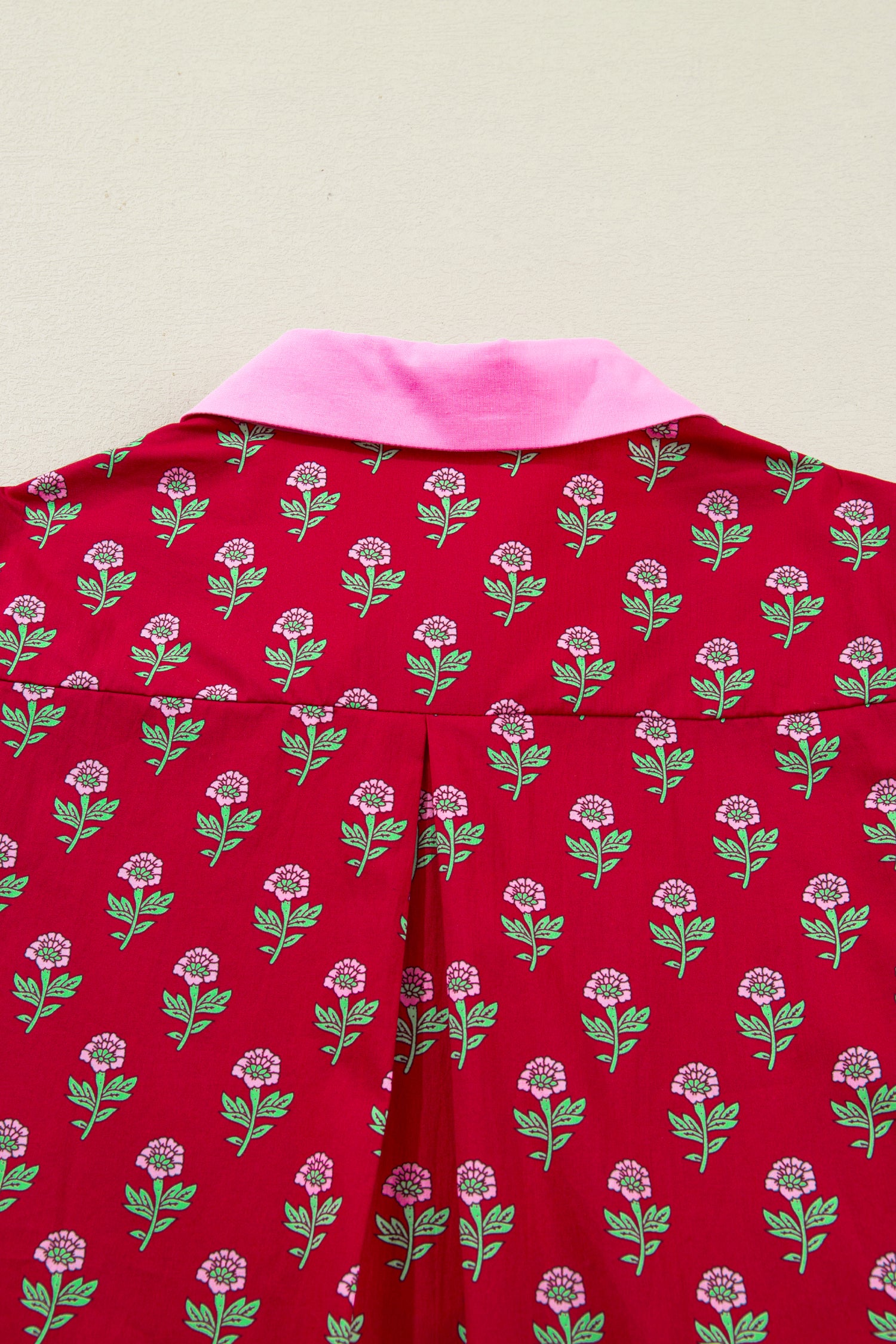 Red floral mini dress with pink collared neckline, mint scalloped trim, short puff sleeves, and a ruffled drop-waist hem