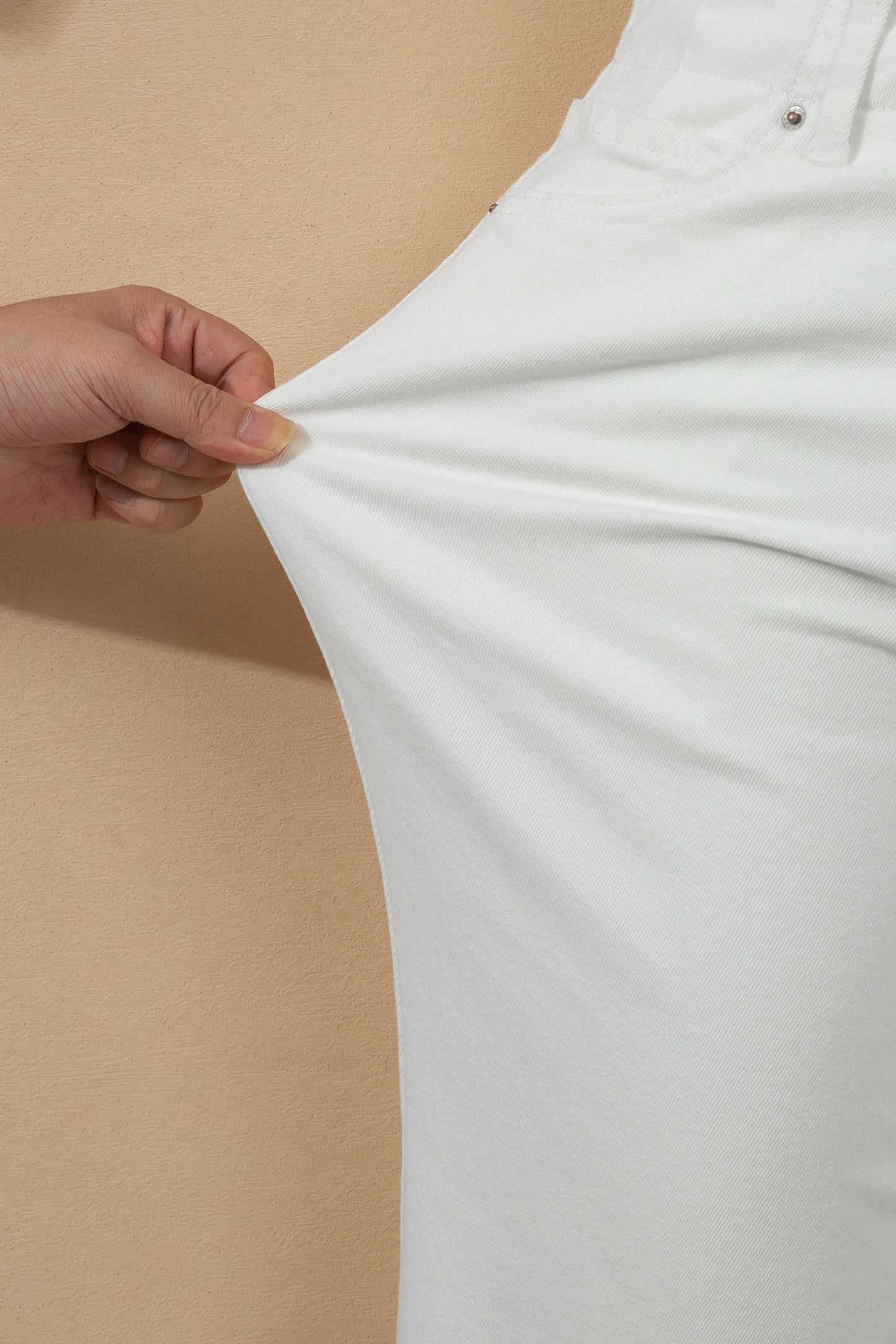 White high rise wide leg jeans with double-button waistband, front pockets and cropped hem.
