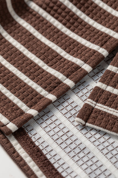 Cocoa Caramel and ivory striped colorblock pullover with a collared V-neckline, dropped shoulders, and long paneled sleeves.