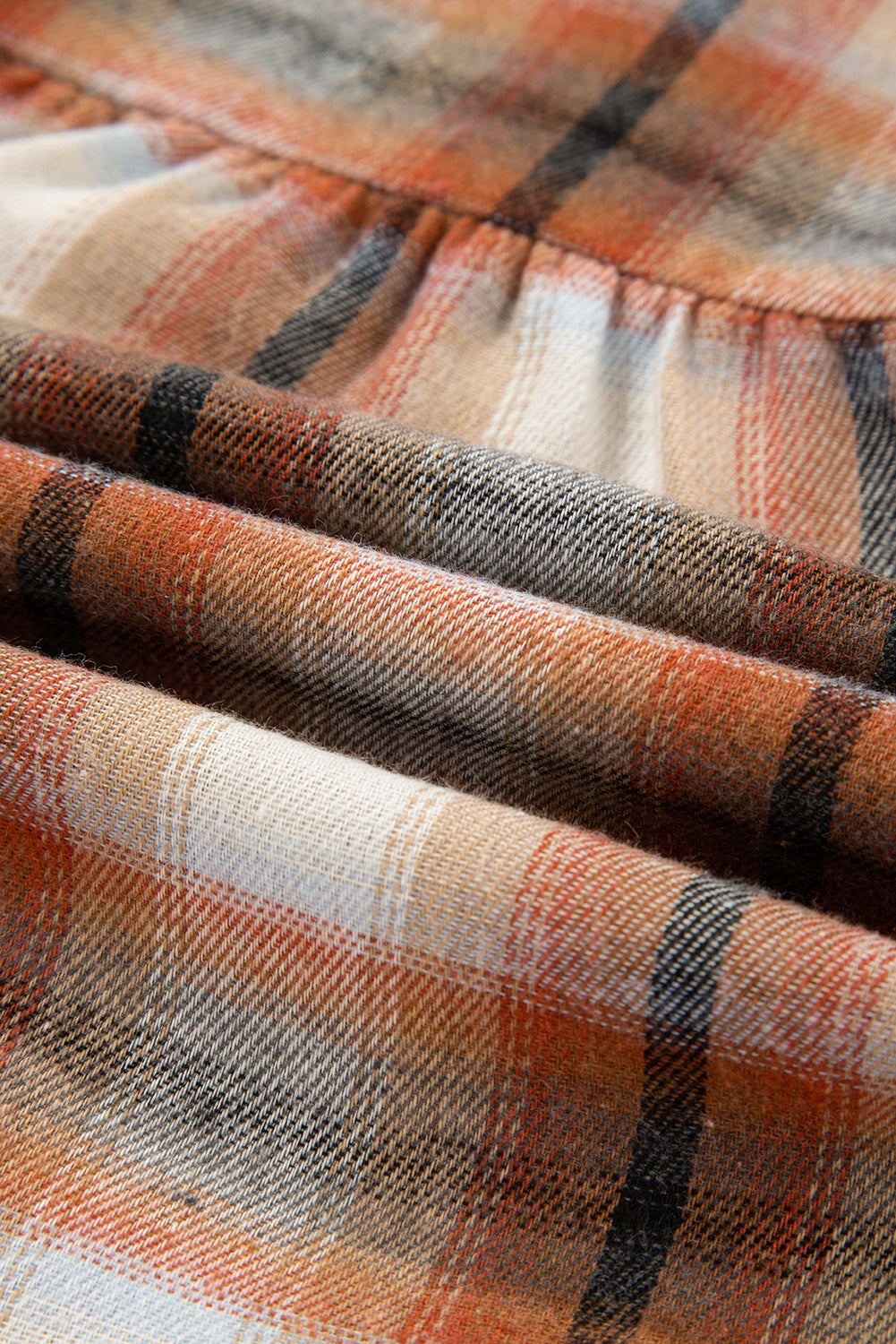 Caramel plaid tunic shirt dress with collared neckline, button front, chest pockets, long sleeves, and relaxed mini silhouette.