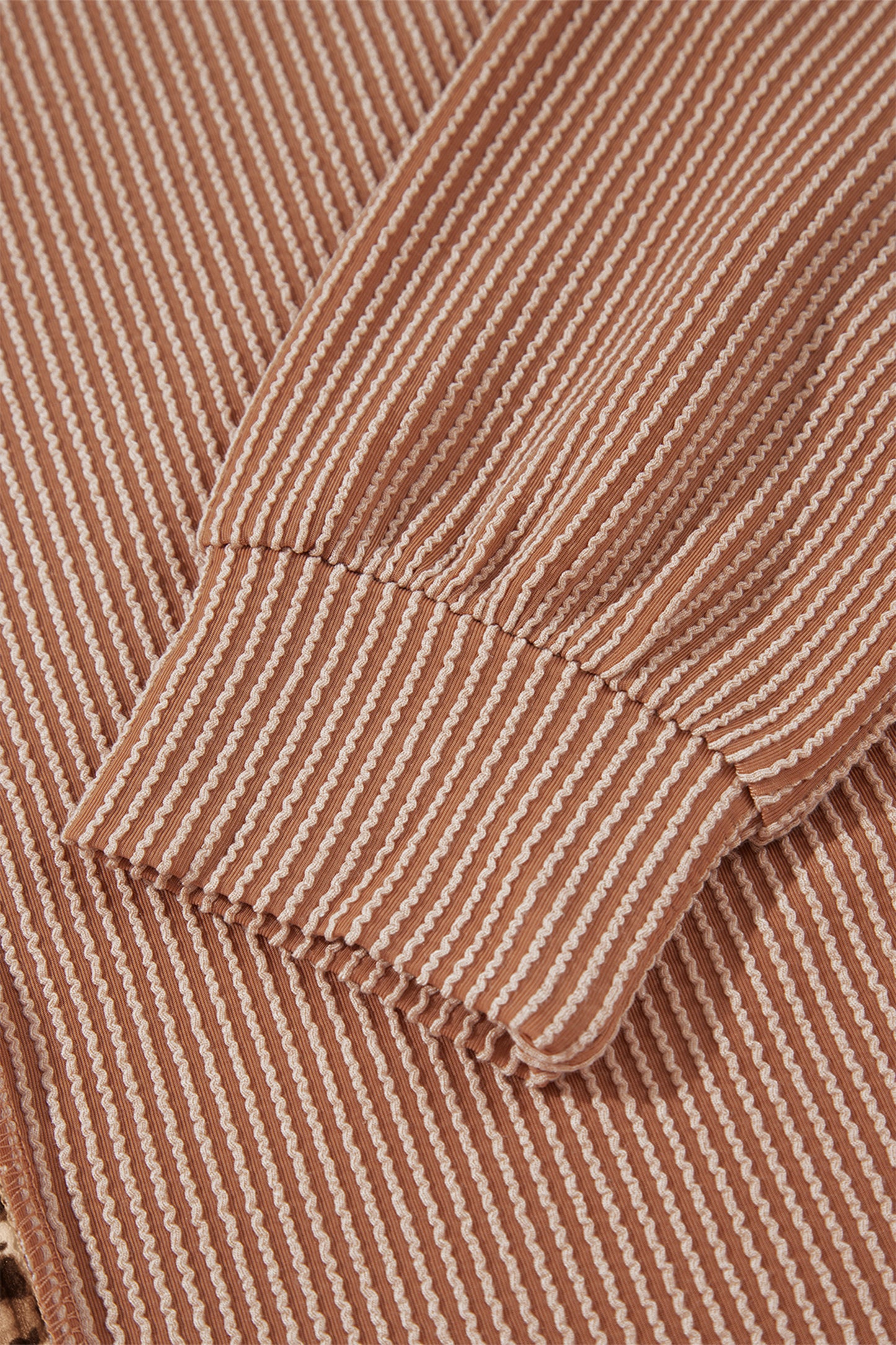 mocha brown leopard colorblock ribbed knit top with a round neckline, dropped shoulders, relaxed fit, and long sleeves.