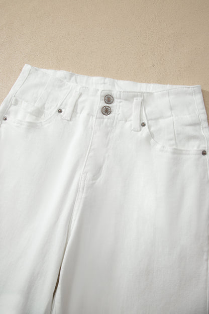 White high rise wide leg jeans with double-button waistband, front pockets and cropped hem.