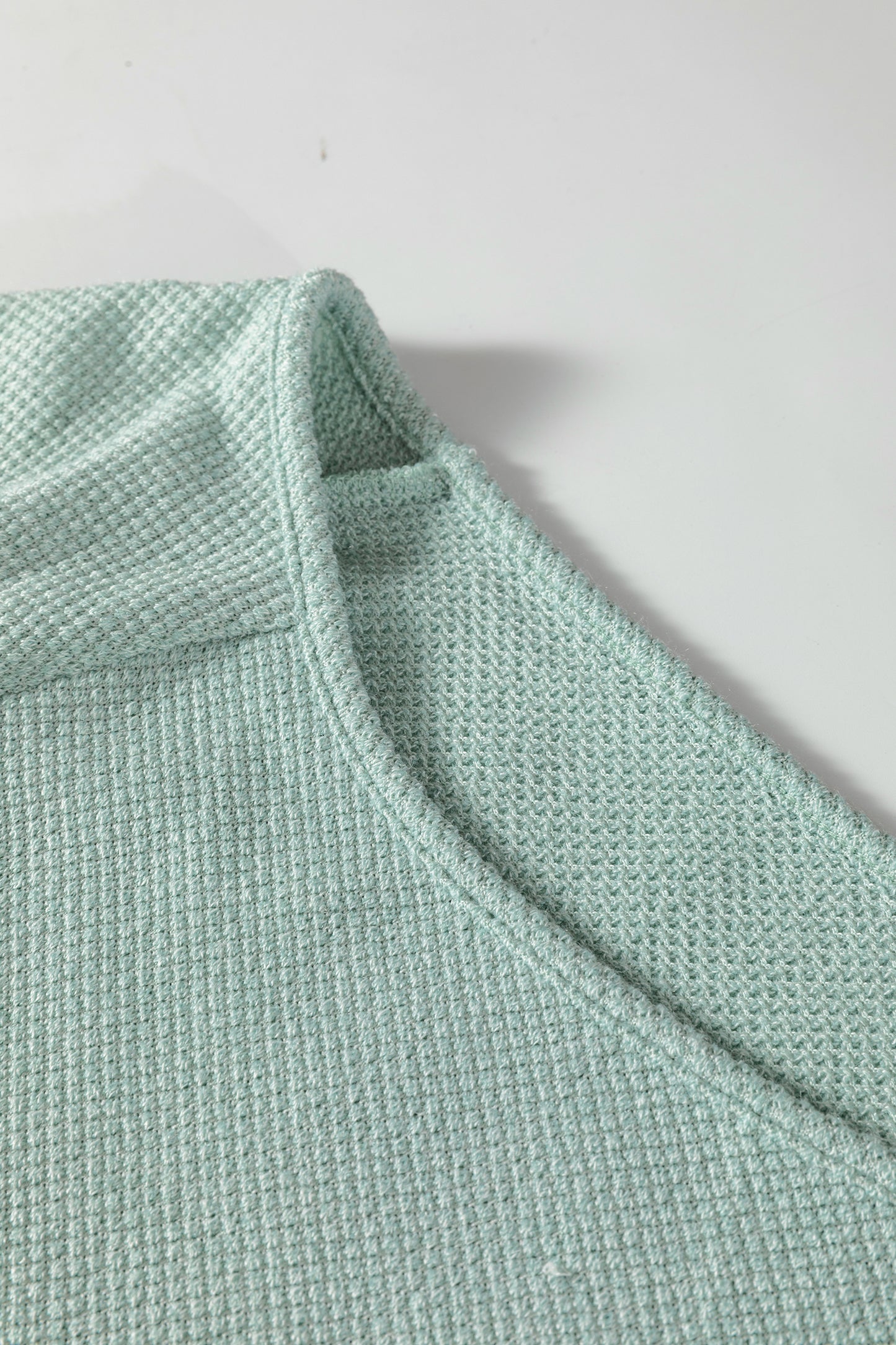 Seafoam Mist textured raglan long sleeve top with round neckline, relaxed fit, and curved hem