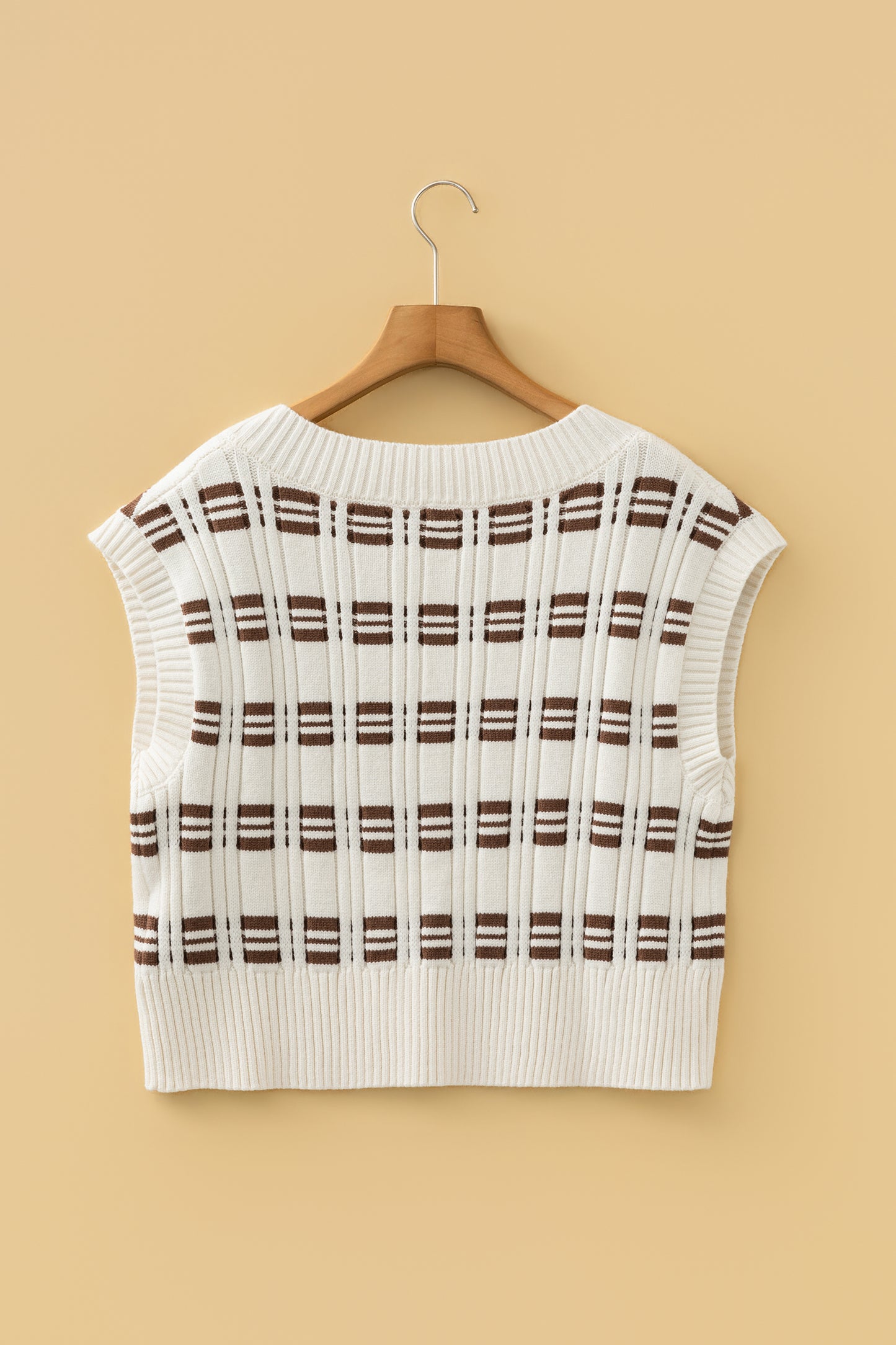 Oatmeal knit sweater vest with brown striped pattern, V-neckline, sleeveless design, and ribbed trim.