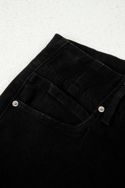 Black high rise wide leg jeans with double-button waistband, front pockets and cropped hem.