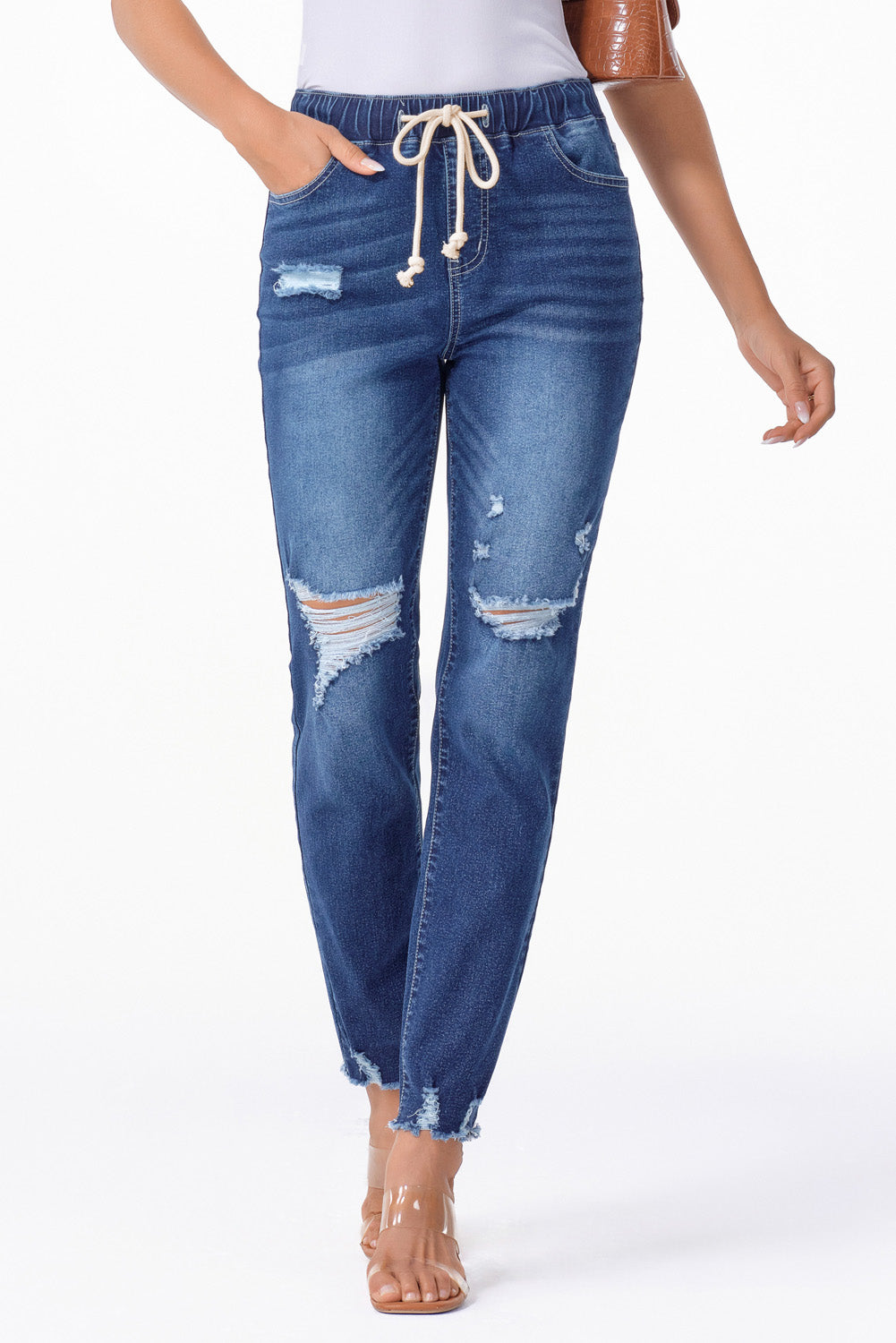 Medium wash blue distressed slim straight leg jeans with drawstring elastic waist and raw hem