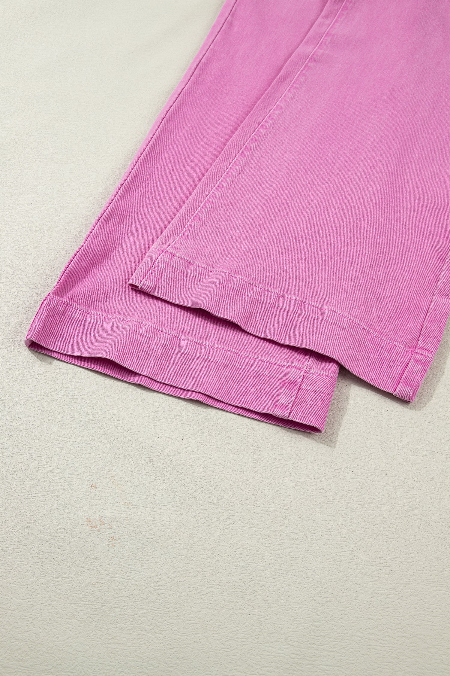 Pink high rise wide leg jeans with double-button waistband, front pockets and cropped hem.