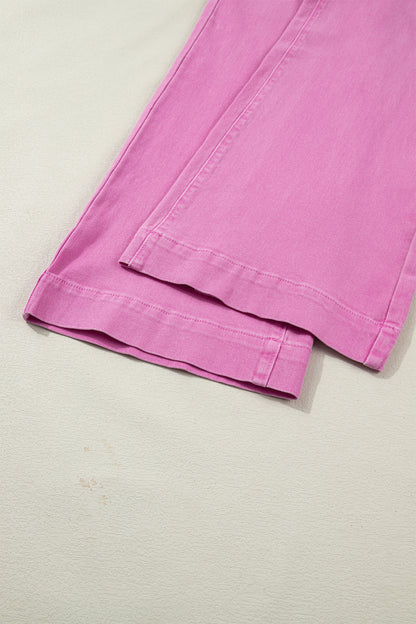 Pink high rise wide leg jeans with double-button waistband, front pockets and cropped hem.
