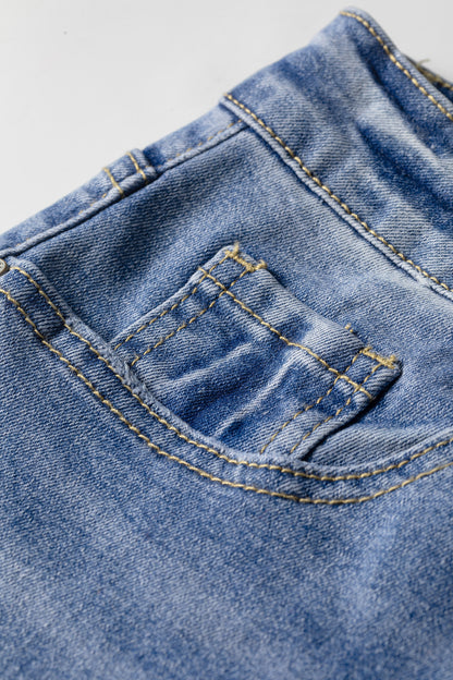 Light Wash Blue high rise Western flare jeans with embroidered lower-leg detailing and full-length wide leg silhouette.