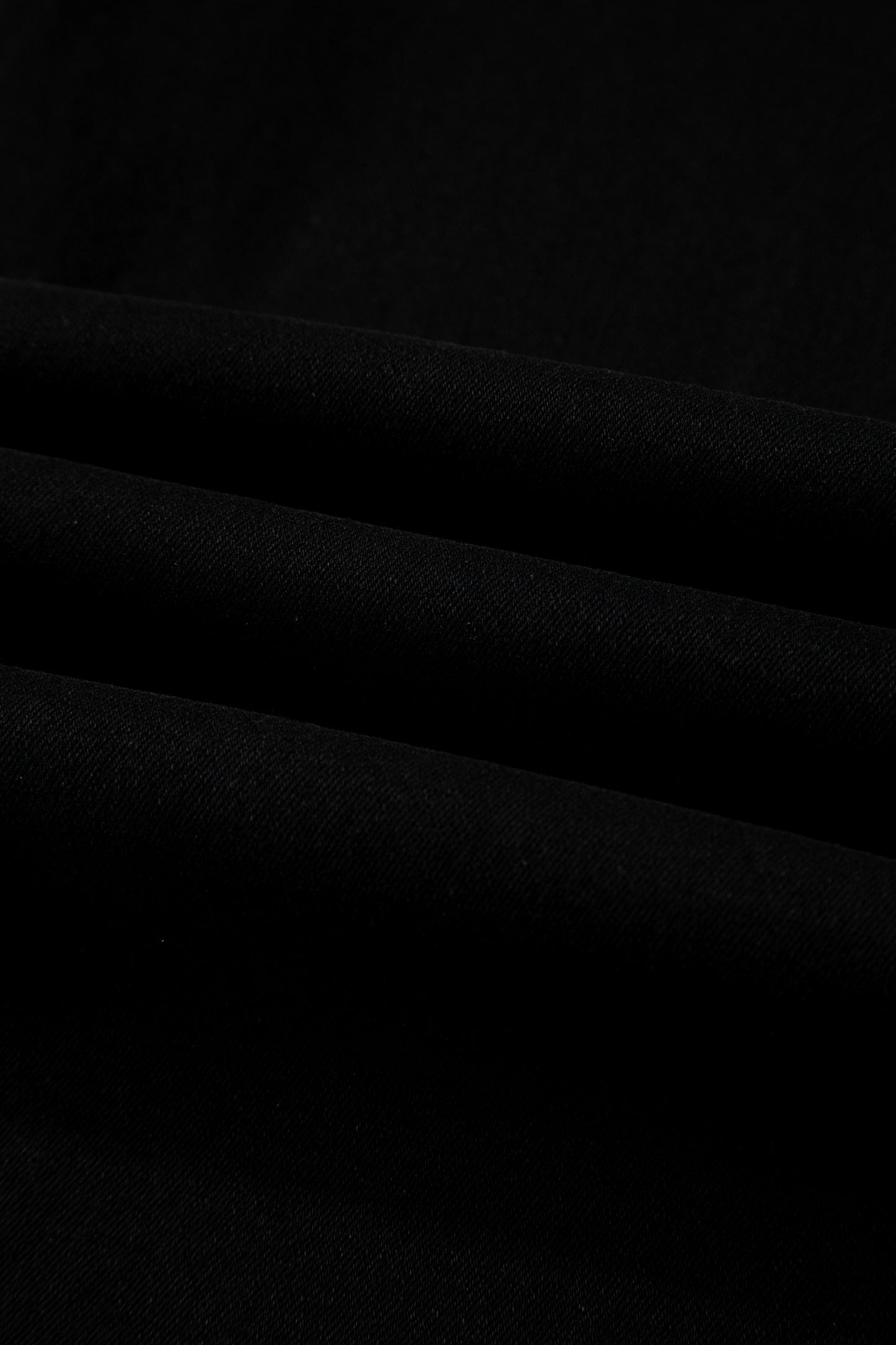 Black high rise wide leg jeans with double-button waistband, front pockets and cropped hem.