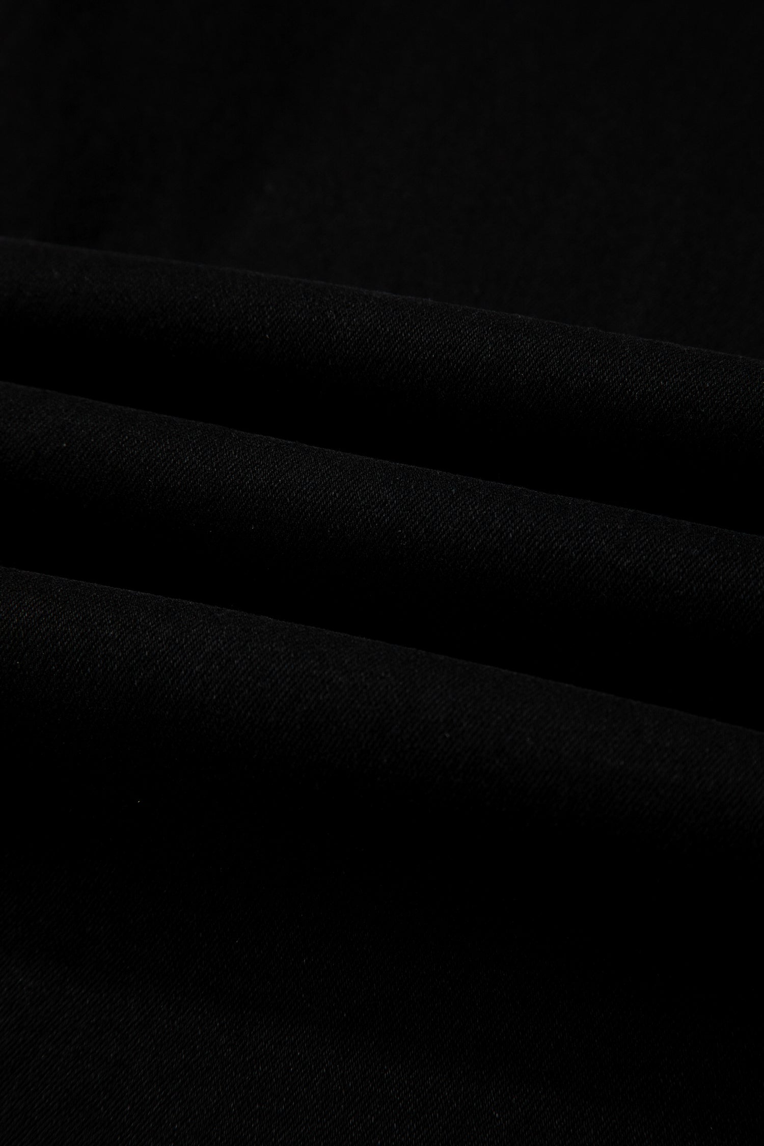Black high rise wide leg jeans with double-button waistband, front pockets and cropped hem.