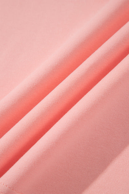 Pink crew neck long sleeve top with asymmetrical paneled body design and blue striped color block sleeves with contrasting orange accents.