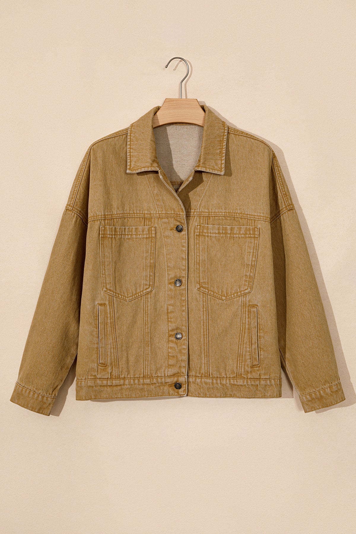 Tan women's denim jacket with metal button front, collared neckline, long sleeves, patch pockets, and relaxed fit.