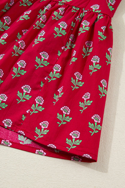Red floral mini dress with pink collared neckline, mint scalloped trim, short puff sleeves, and a ruffled drop-waist hem