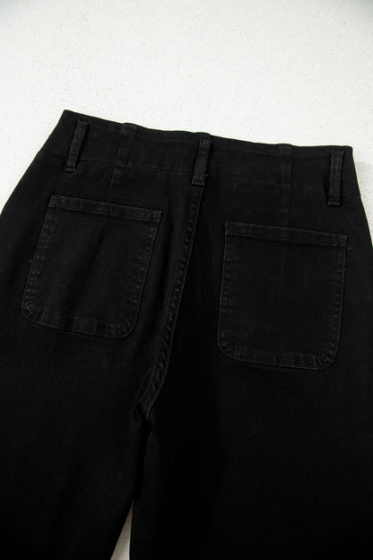 Black high rise wide leg jeans with double-button waistband, front pockets and cropped hem.