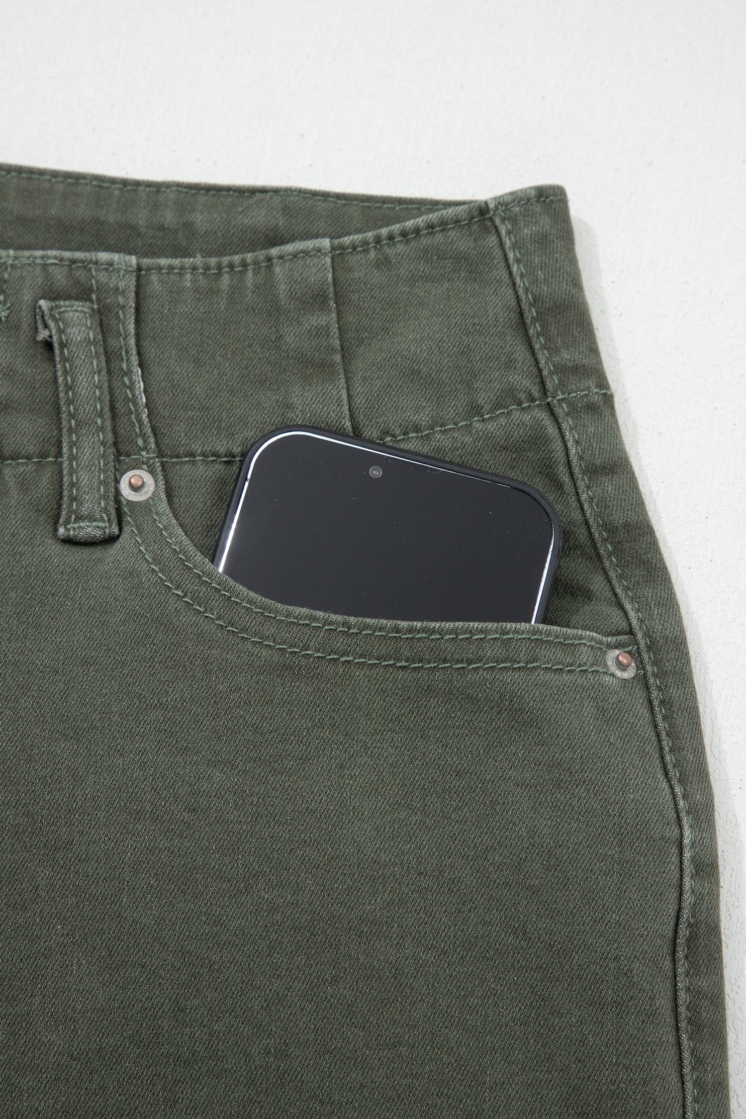 Olive green high rise wide leg jeans with double-button waistband, front pockets and cropped hem.