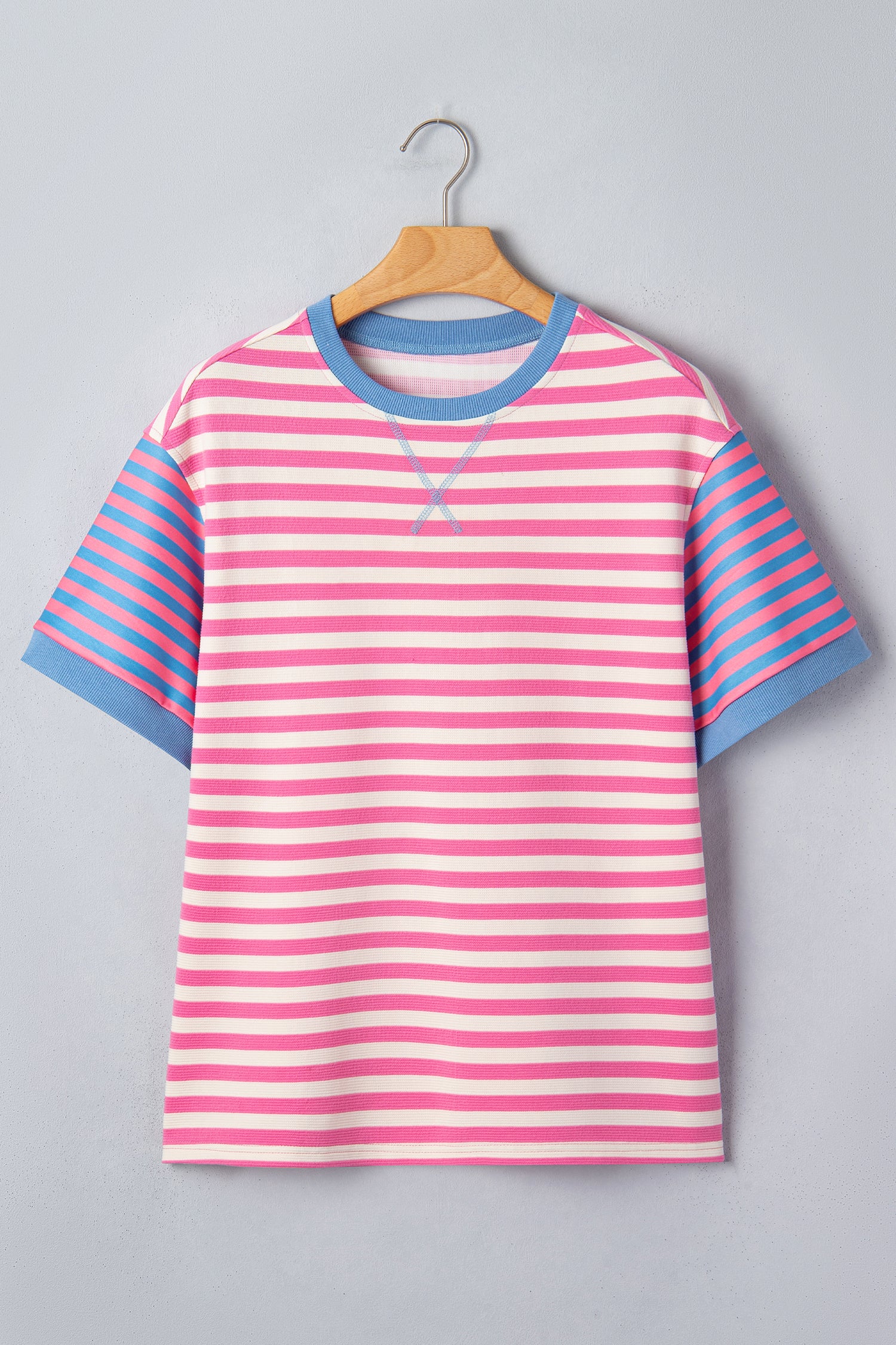 Pink and white textured striped knit short sleeve top with blue contrast ribbed neckline and sleeve cuffs, relaxed fit, and crew neckline.