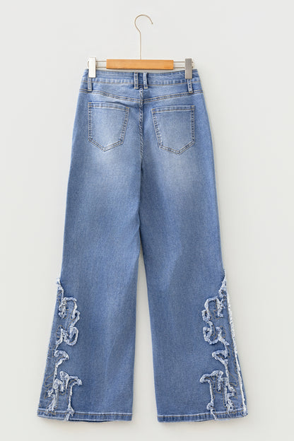 Light Wash Blue high rise Western flare jeans with embroidered lower-leg detailing and full-length wide leg silhouette.