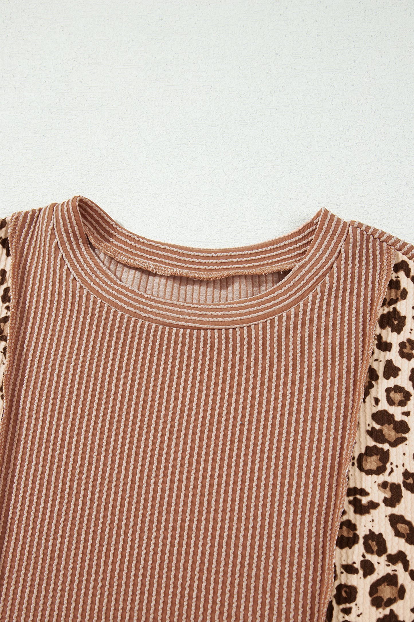 mocha brown leopard colorblock ribbed knit top with a round neckline, dropped shoulders, relaxed fit, and long sleeves.