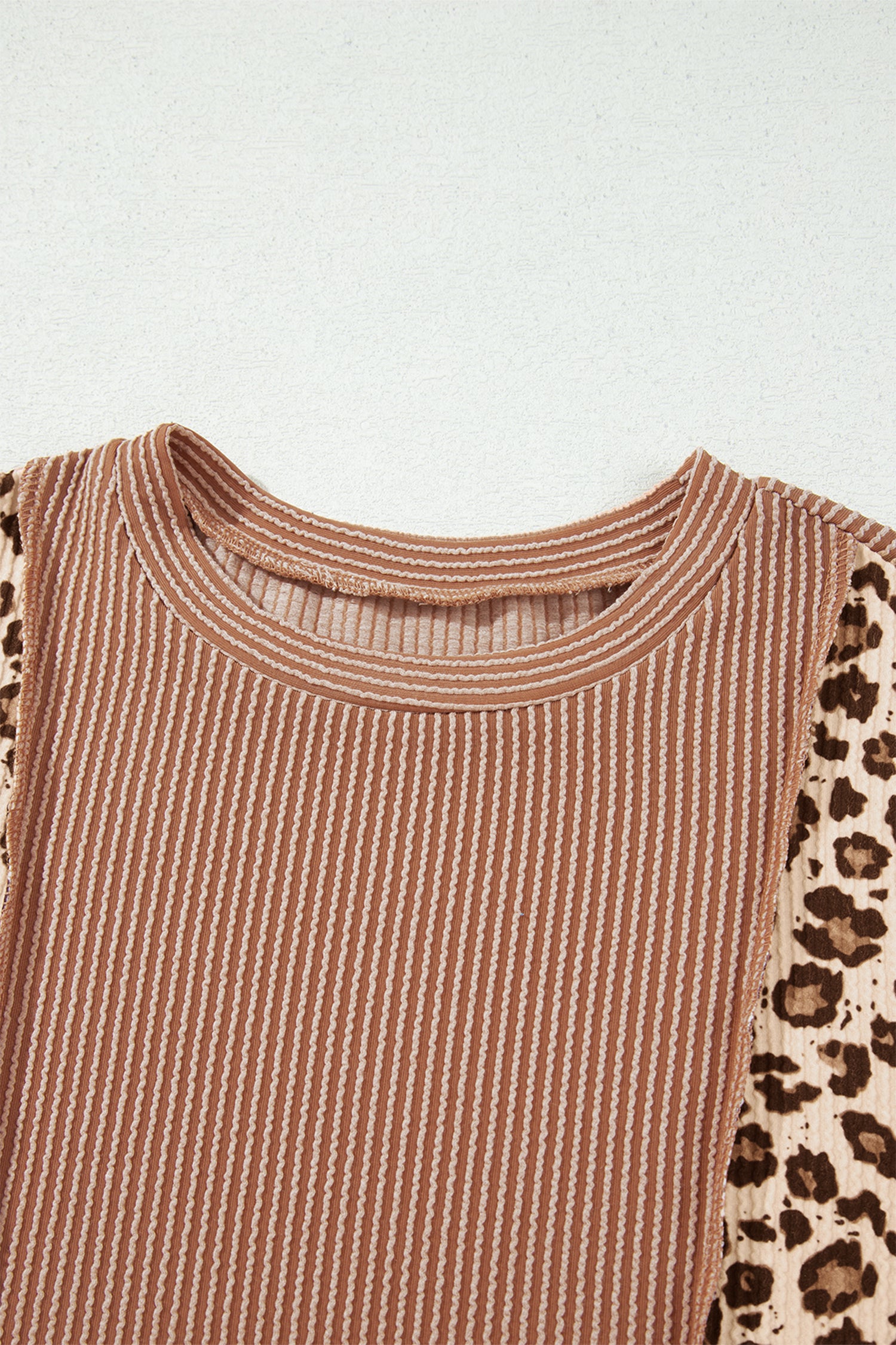 mocha brown leopard colorblock ribbed knit top with a round neckline, dropped shoulders, relaxed fit, and long sleeves.