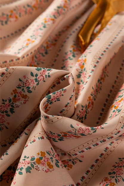 Blush floral babydoll mini dress with floral stripe print, cream lace-trimmed square neckline, brown velvet bow, and long sleeves.