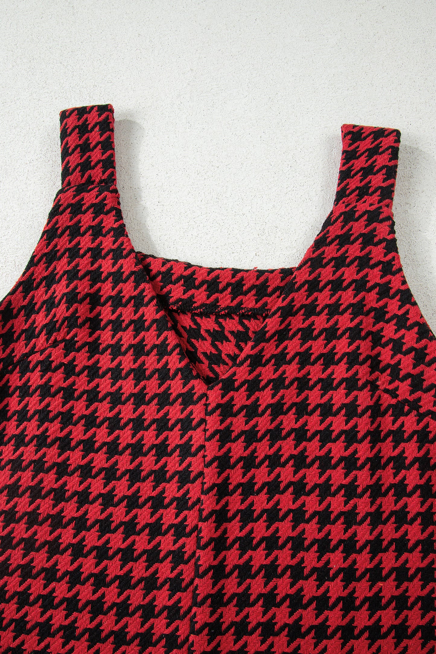Red textured houndstooth jacquard sleeveless mini dress with V-neckline and A-line silhouette.