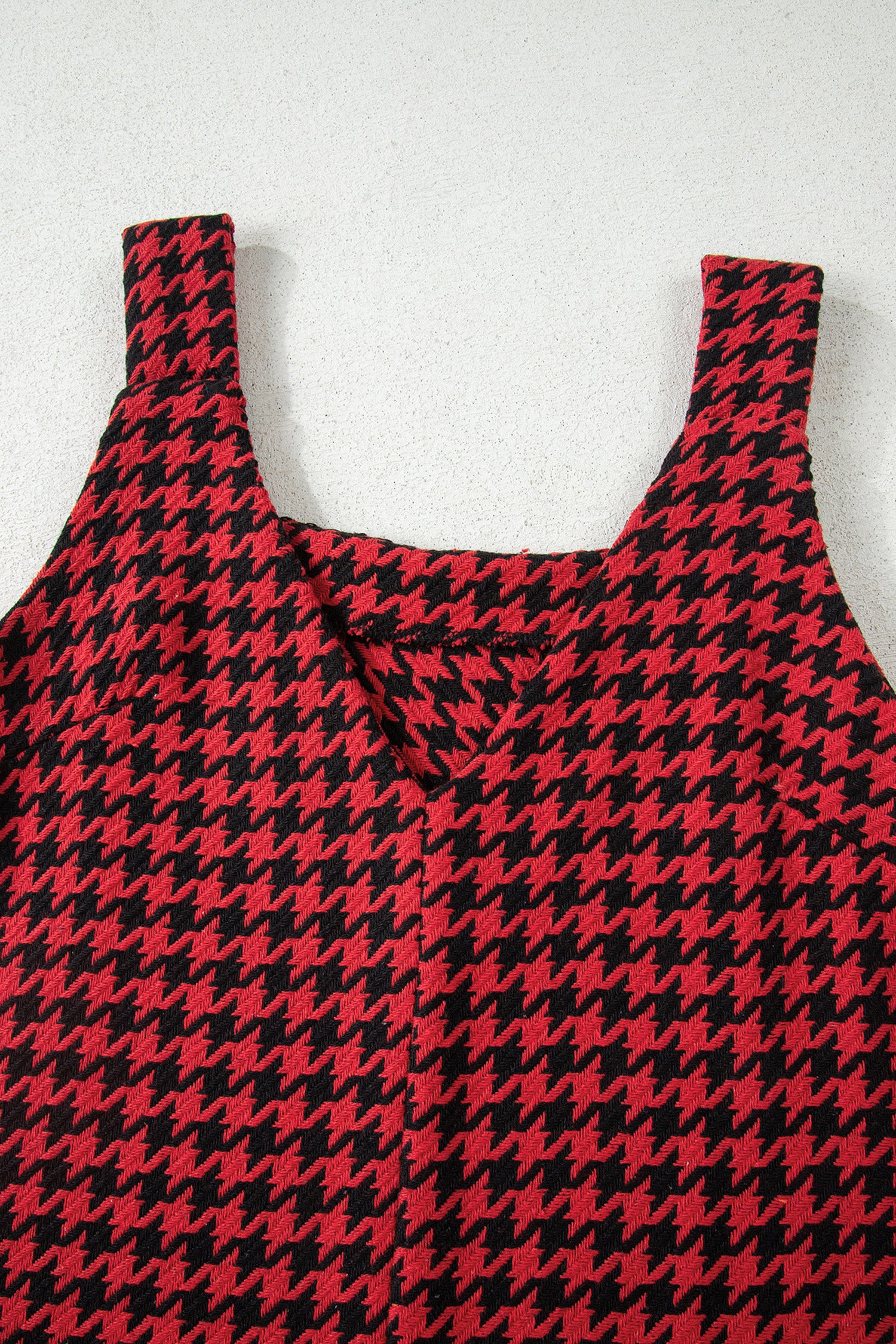 Red textured houndstooth jacquard sleeveless mini dress with V-neckline and A-line silhouette.