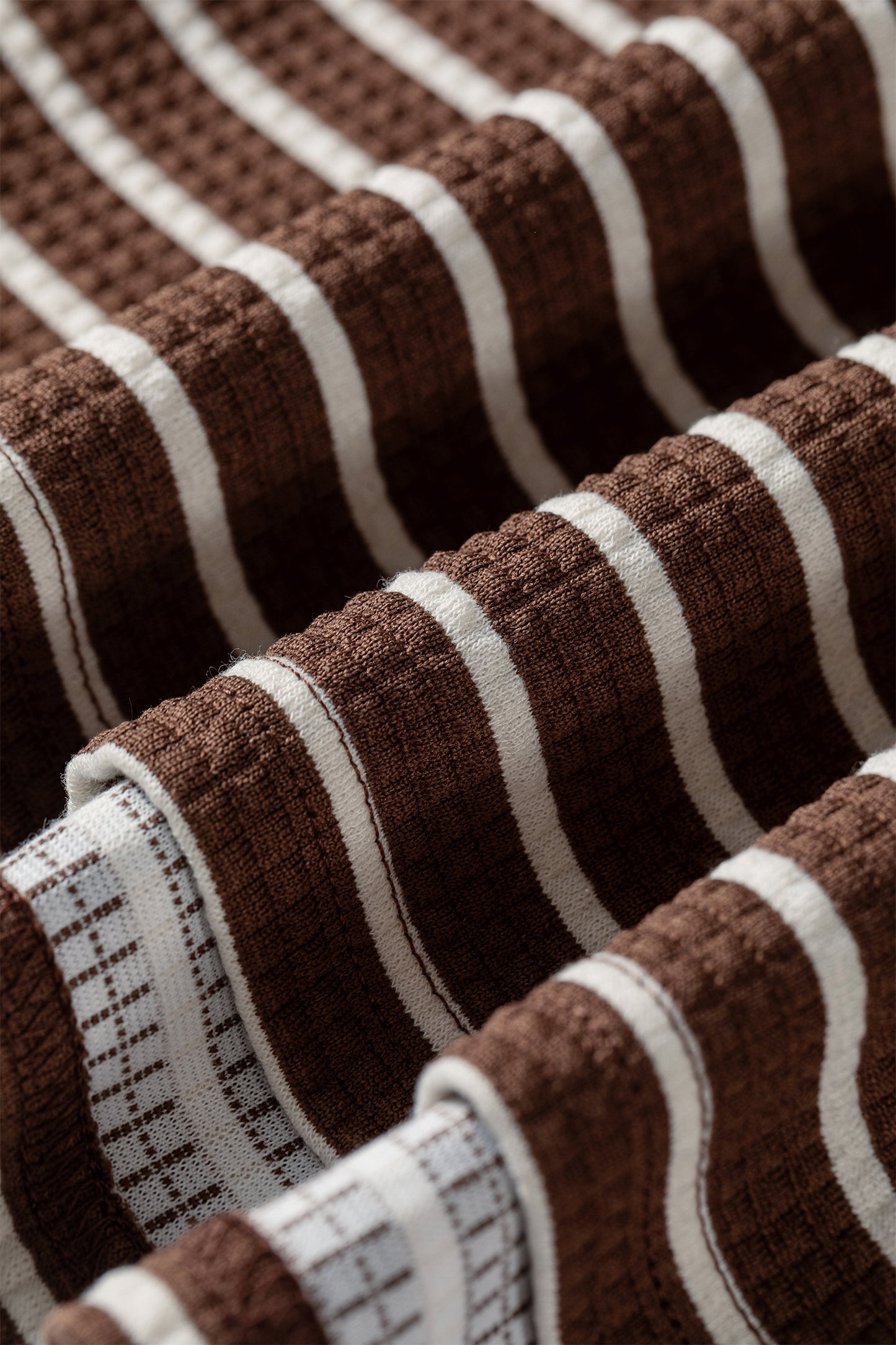 Cocoa Caramel and ivory striped colorblock pullover with a collared V-neckline, dropped shoulders, and long paneled sleeves.