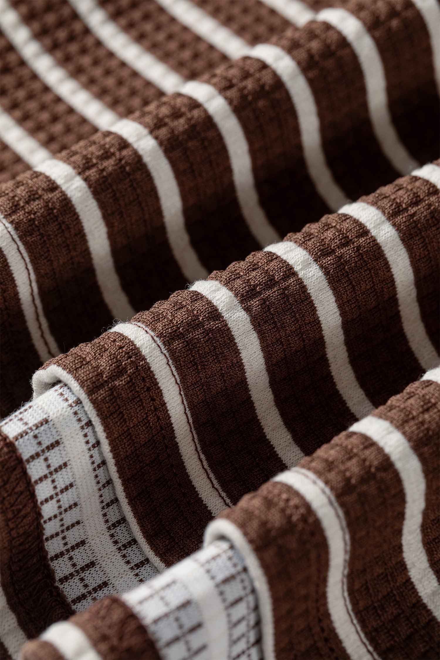 Cocoa Caramel and ivory striped colorblock pullover with a collared V-neckline, dropped shoulders, and long paneled sleeves.