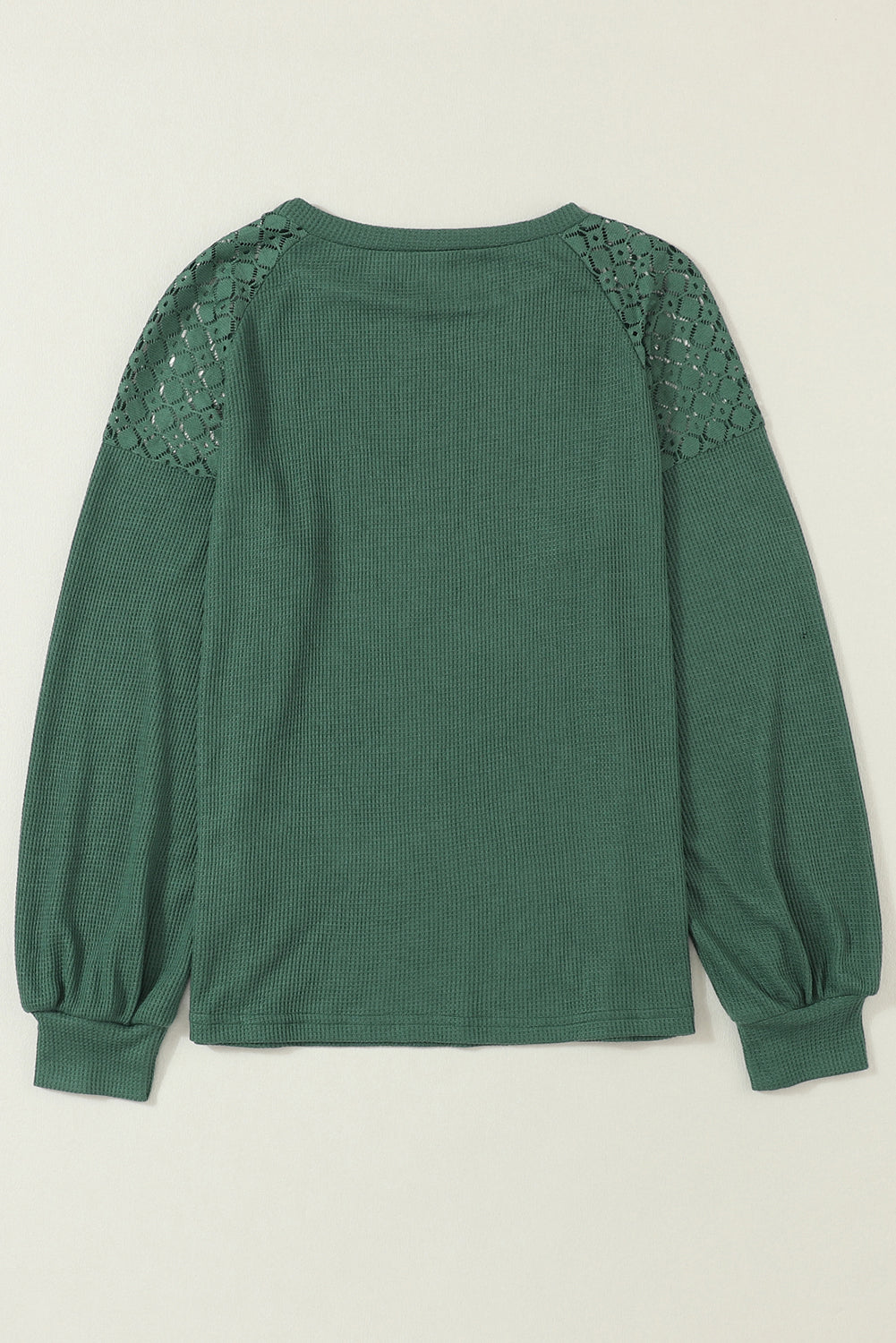 Forest green waffle knit long sleeve top with floral lace shoulder panels, crew neckline, relaxed fit, and balloon sleeves.