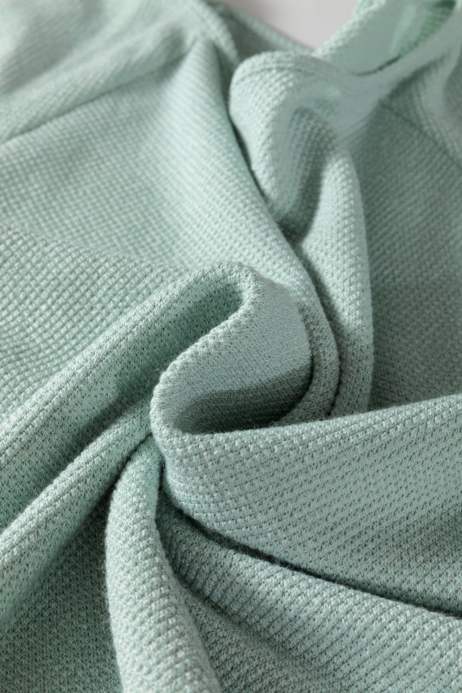 Seafoam Mist textured raglan long sleeve top with round neckline, relaxed fit, and curved hem