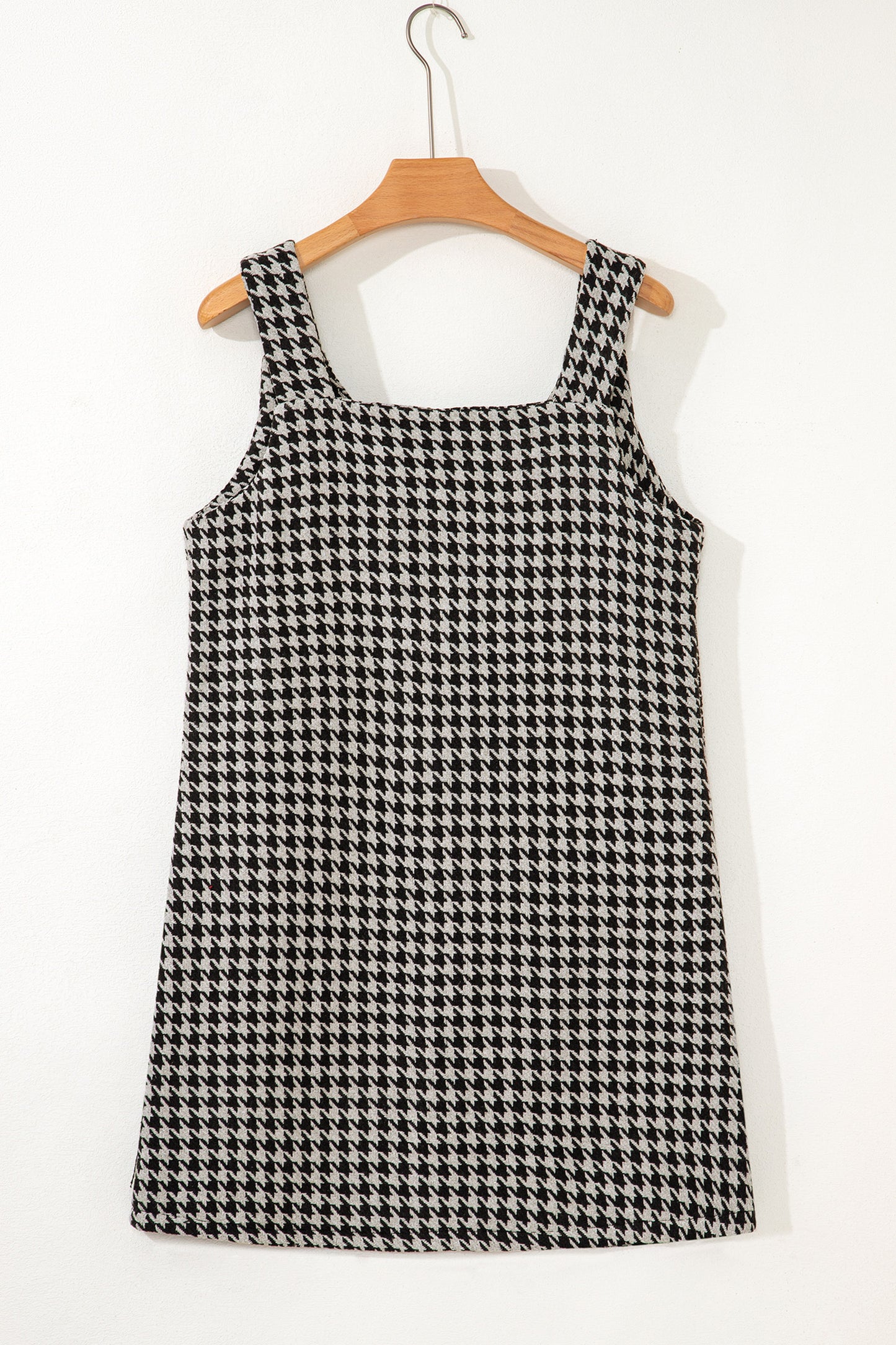 Black textured houndstooth jacquard sleeveless mini dress with V-neckline and A-line silhouette.