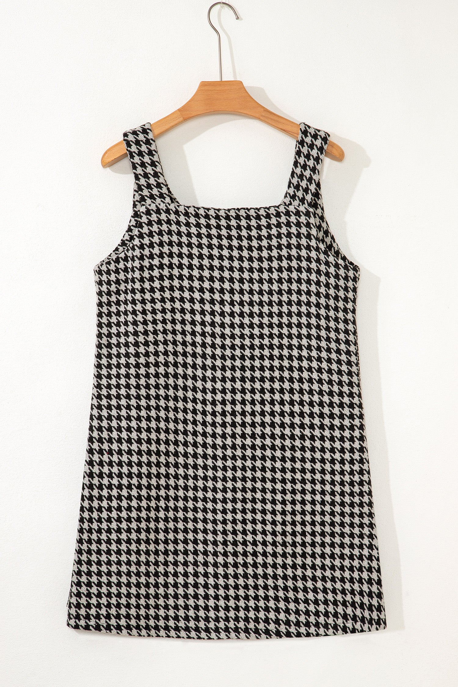 Black textured houndstooth jacquard sleeveless mini dress with V-neckline and A-line silhouette.