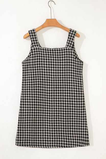 Black textured houndstooth jacquard sleeveless mini dress with V-neckline and A-line silhouette.