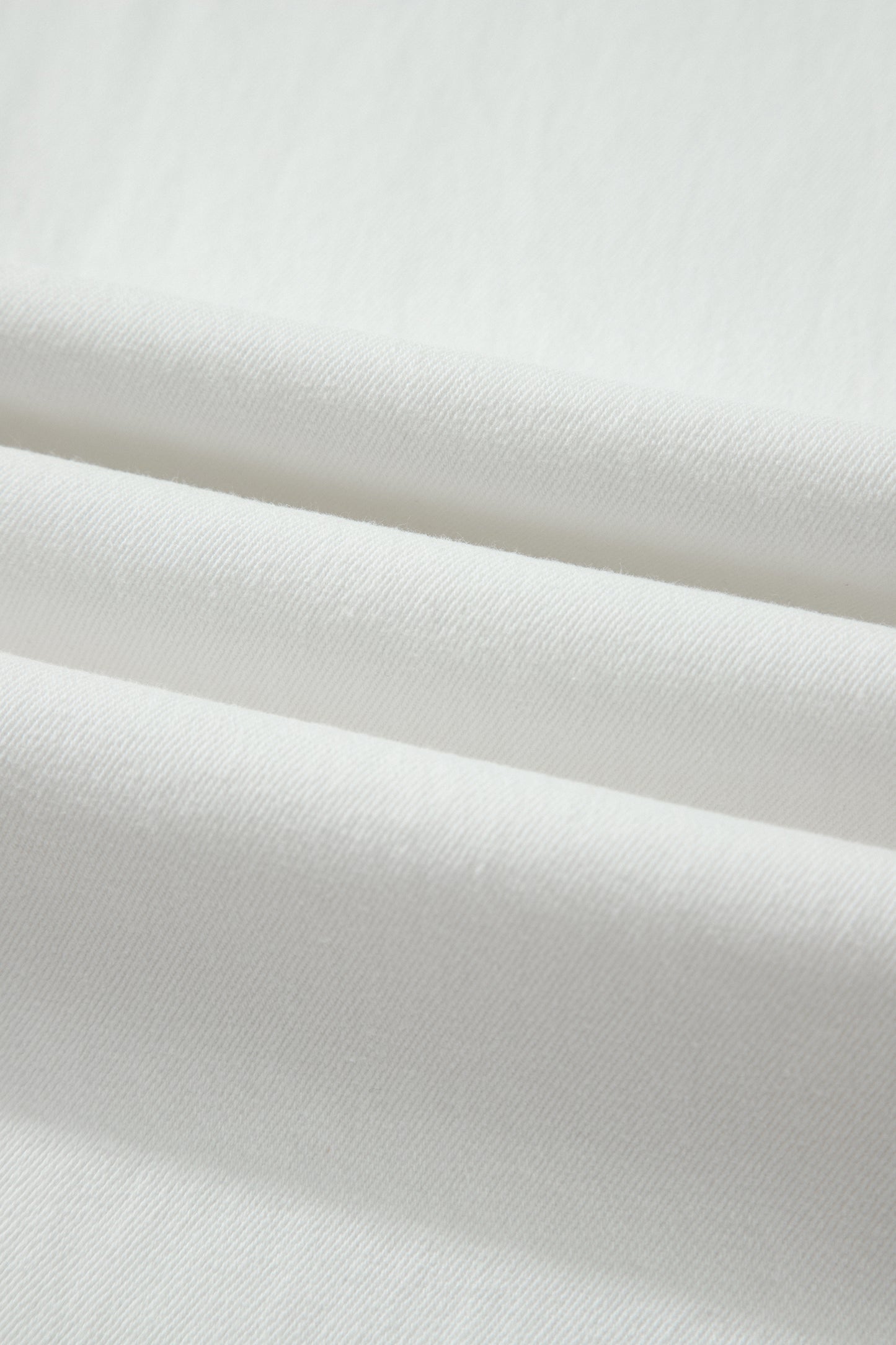 White high rise wide leg jeans with double-button waistband, front pockets and cropped hem.