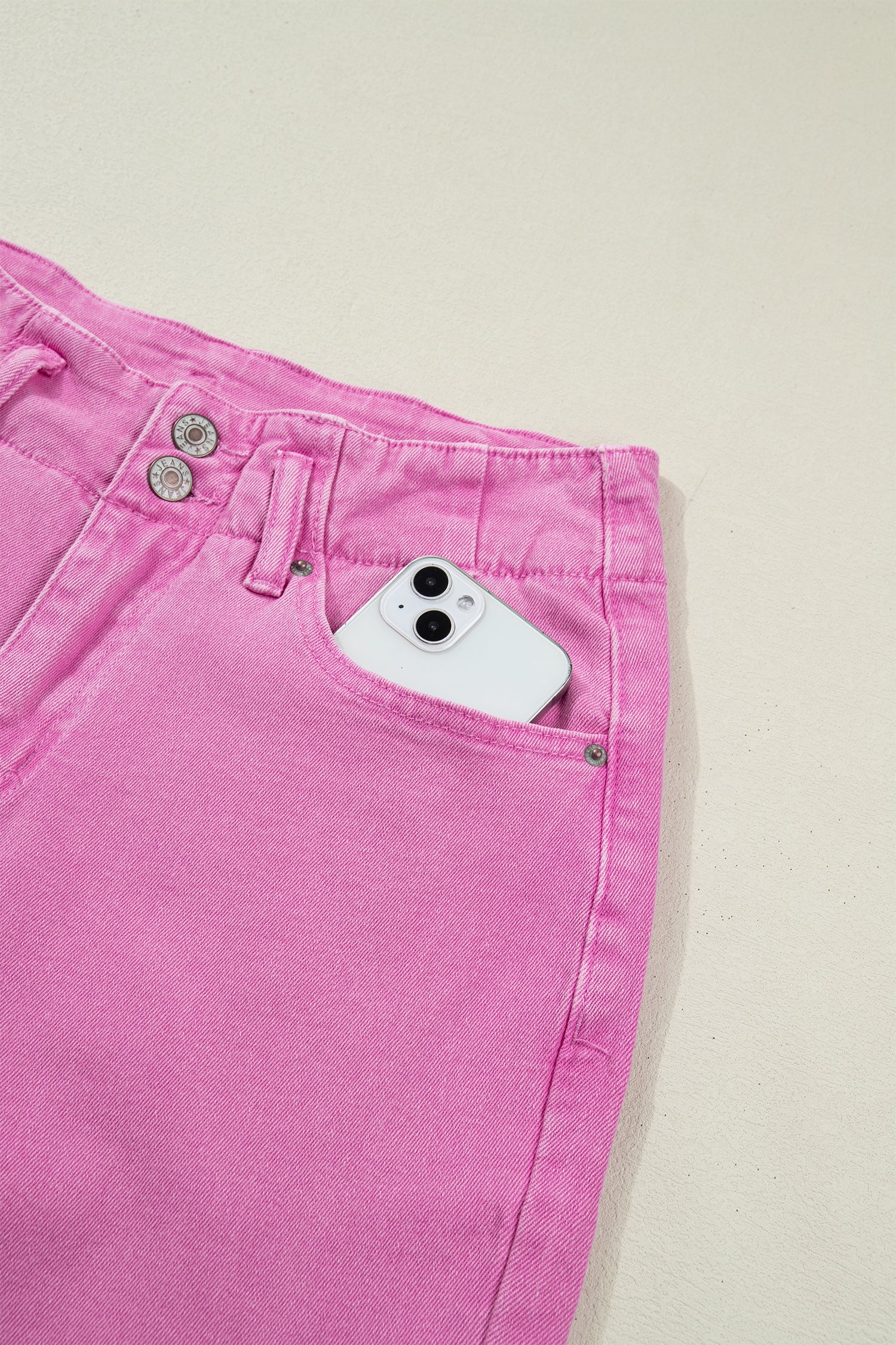 Pink high rise wide leg jeans with double-button waistband, front pockets and cropped hem.