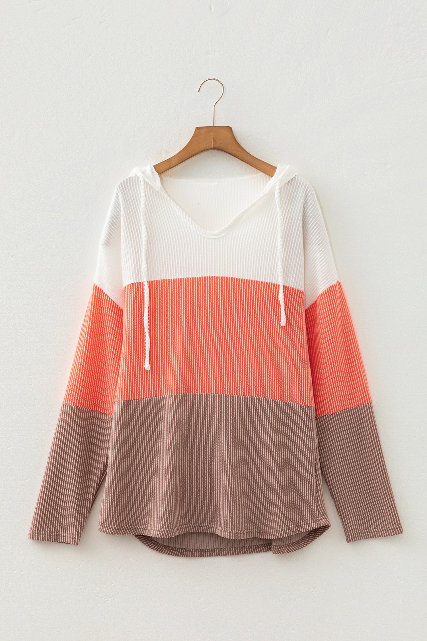 Women's ribbed color block hooded top in ivory, coral, and taupe with a V-neckline, drawstrings, long sleeves, and relaxed fit.