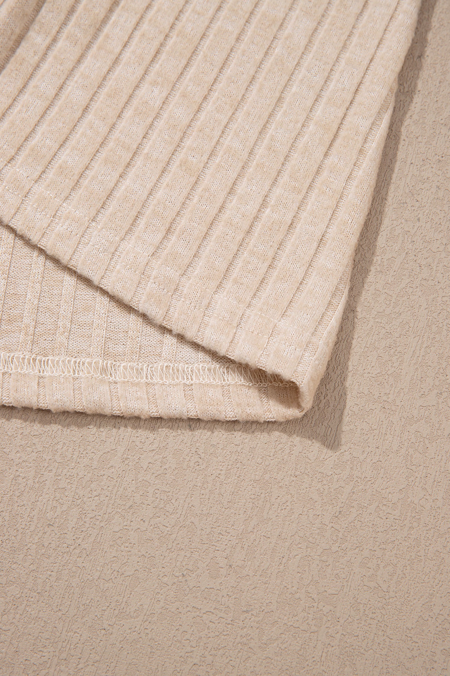 Oatmeal women's long sleeve top with fine vertical ribbed texture, a softly draped cowl neckline, and a flattering fitted silhouette.