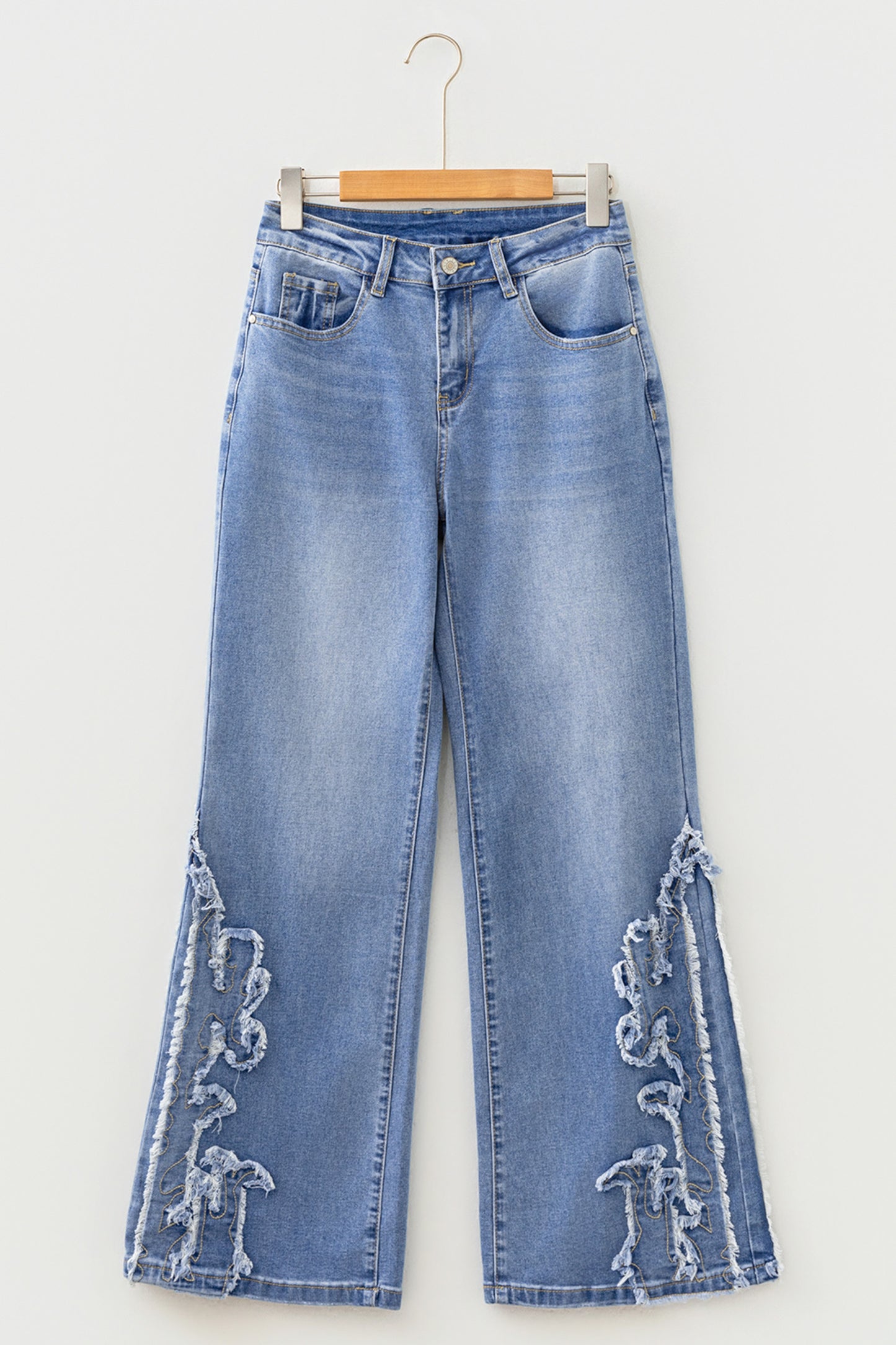 Light Wash Blue high rise Western flare jeans with embroidered lower-leg detailing and full-length wide leg silhouette.