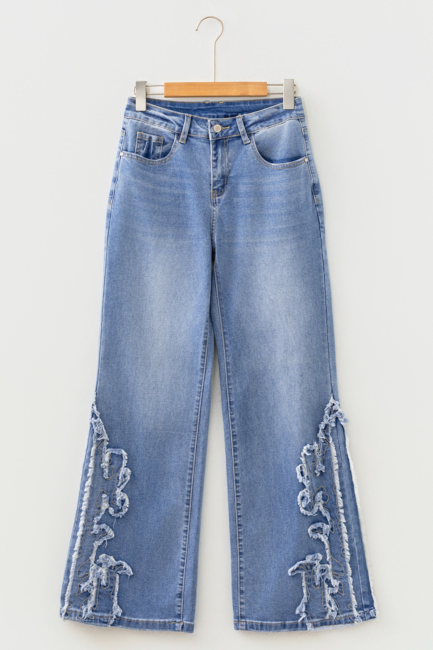 Light Wash Blue high rise Western flare jeans with embroidered lower-leg detailing and full-length wide leg silhouette.
