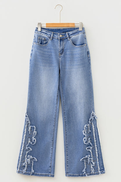 Light Wash Blue high rise Western flare jeans with embroidered lower-leg detailing and full-length wide leg silhouette.