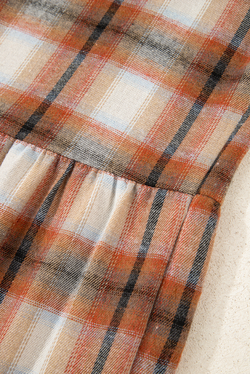 Caramel plaid tunic shirt dress with collared neckline, button front, chest pockets, long sleeves, and relaxed mini silhouette.