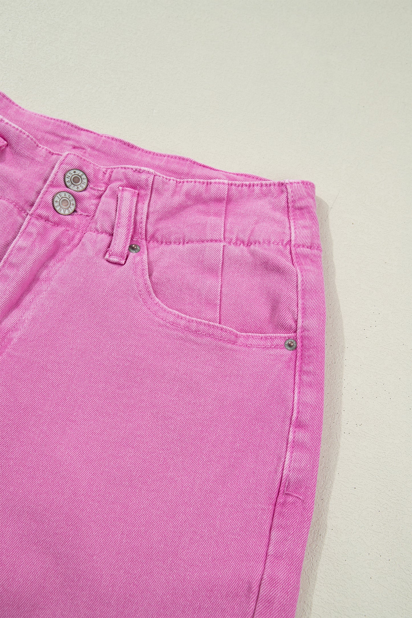 Pink high rise wide leg jeans with double-button waistband, front pockets and cropped hem.