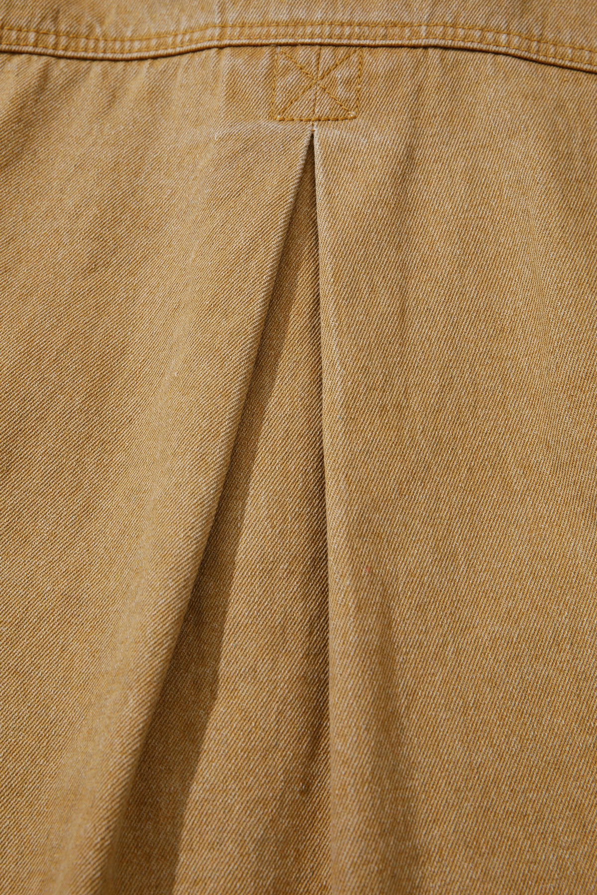 Tan women's denim jacket with metal button front, collared neckline, long sleeves, patch pockets, and relaxed fit.