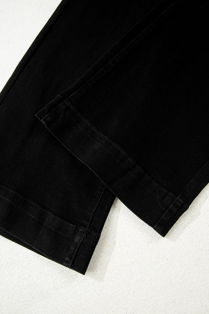 Black high rise wide leg jeans with double-button waistband, front pockets and cropped hem.